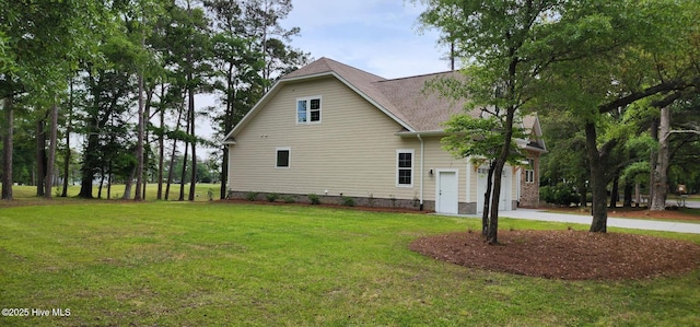 view of home's exterior featuring a garage, a lawn, concrete driveway, and roof with shingles