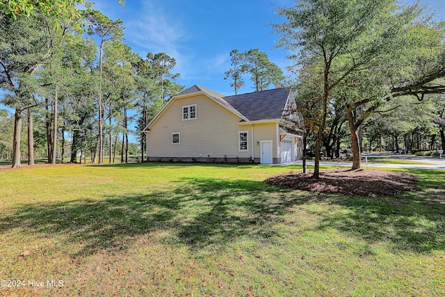 view of side of home featuring a lawn