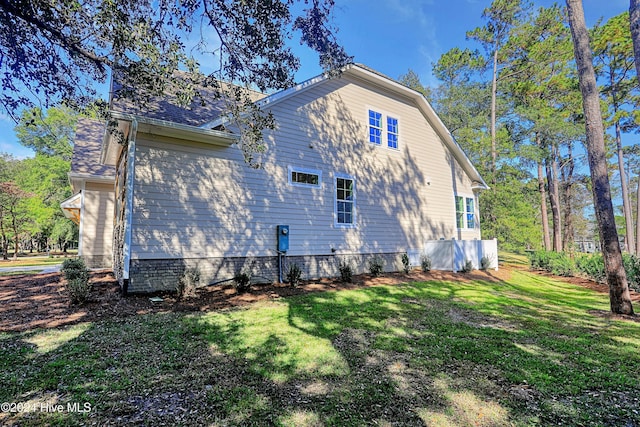 view of home's exterior with a yard