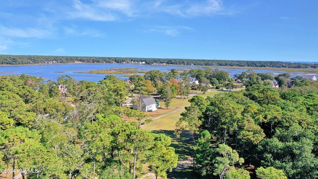 aerial view featuring a forest view and a water view