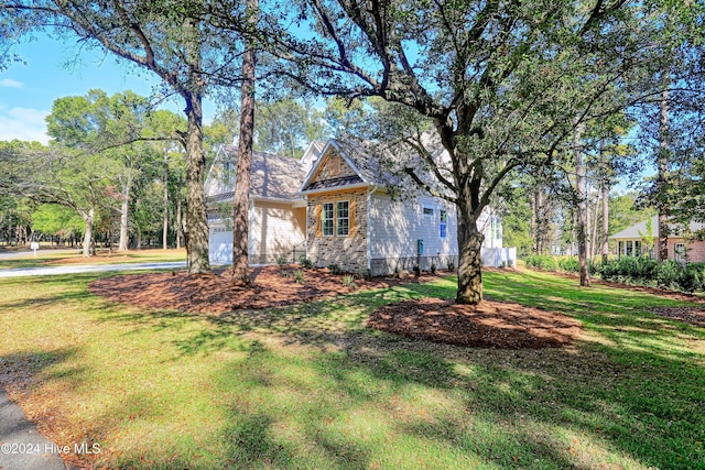 craftsman-style house with a garage and a front yard