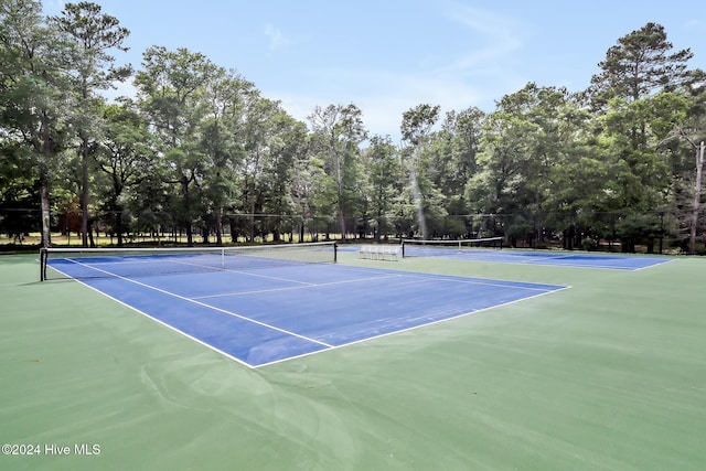 view of sport court featuring fence