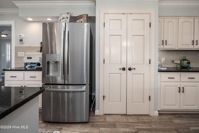 kitchen with white cabinetry, crown molding, dark hardwood / wood-style floors, and stainless steel refrigerator with ice dispenser