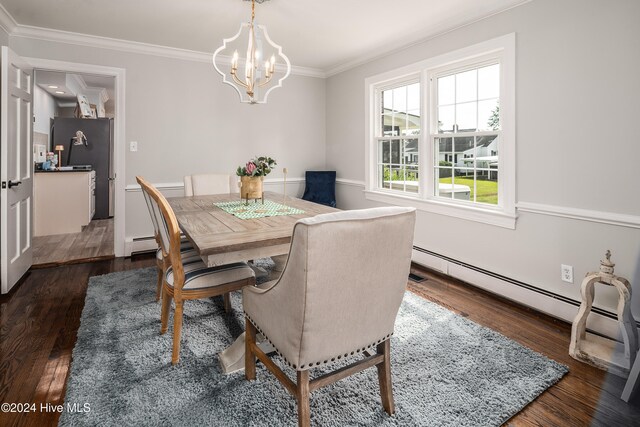 dining room with crown molding, a notable chandelier, baseboard heating, and dark hardwood / wood-style floors