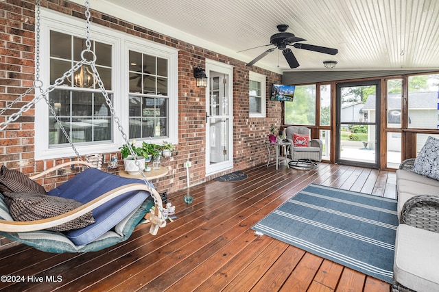 sunroom with wood ceiling, vaulted ceiling, and ceiling fan