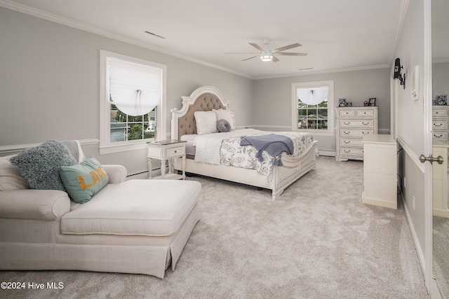 carpeted bedroom with ceiling fan, crown molding, multiple windows, and a baseboard heating unit