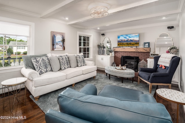 living room featuring beamed ceiling, crown molding, a brick fireplace, and dark hardwood / wood-style floors