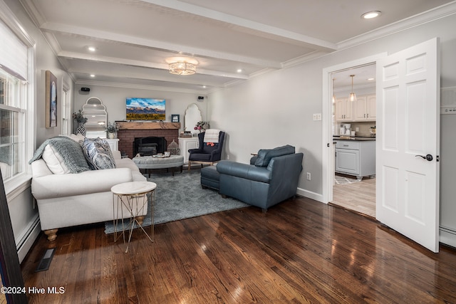 living room with a baseboard heating unit, a fireplace, beamed ceiling, crown molding, and dark hardwood / wood-style floors