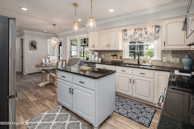 kitchen featuring white cabinets, sink, stainless steel appliances, and a wealth of natural light