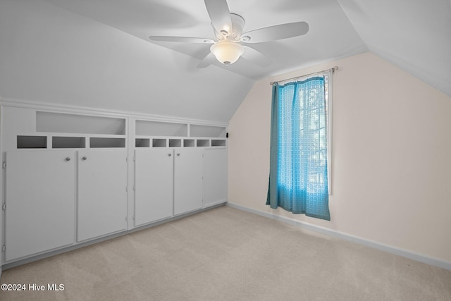 bonus room featuring vaulted ceiling, light colored carpet, and ceiling fan