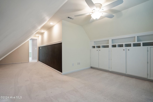 additional living space featuring light carpet, ceiling fan, and vaulted ceiling