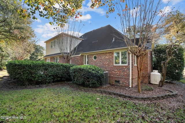 rear view of property featuring a lawn