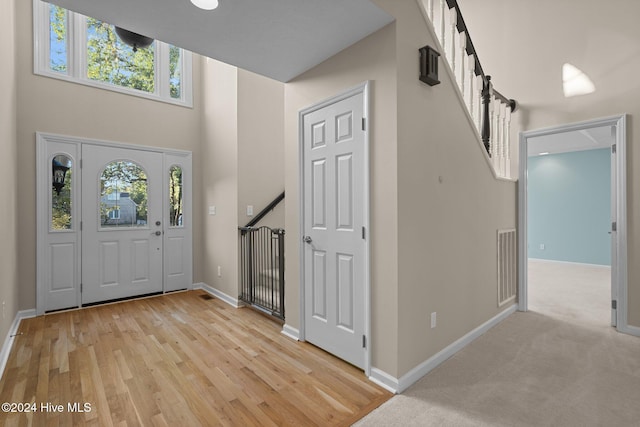 foyer featuring a high ceiling and light wood-type flooring