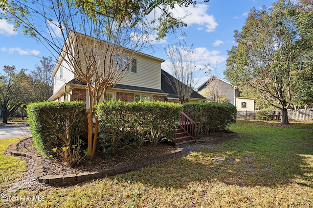 view of side of property featuring a yard