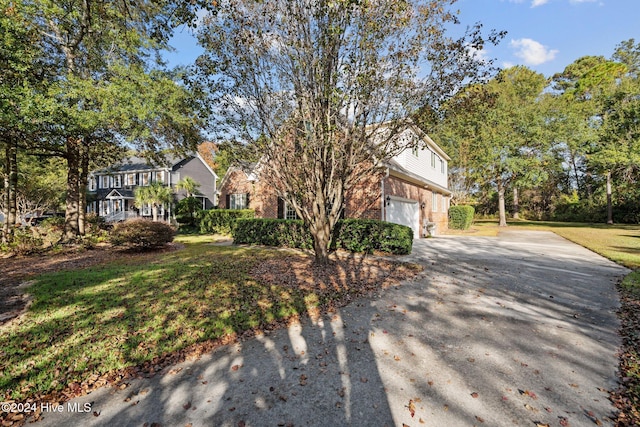 view of front facade with a garage and a front lawn