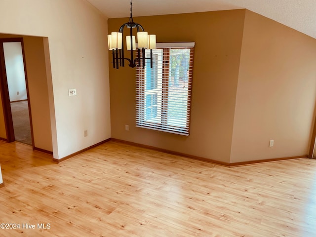 unfurnished dining area with a notable chandelier and light wood-type flooring