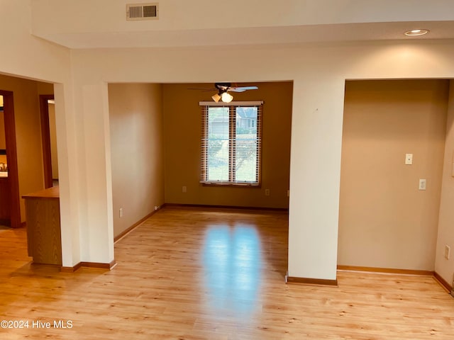 empty room featuring ceiling fan and light hardwood / wood-style flooring