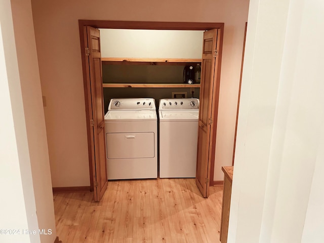 washroom with washer and dryer and light wood-type flooring