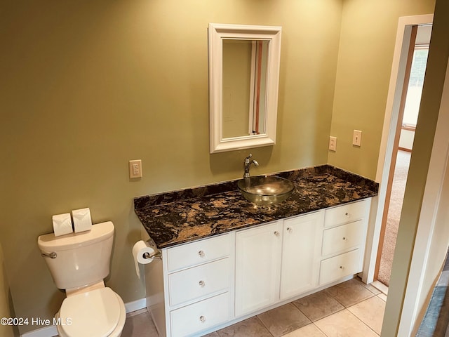 bathroom with tile patterned flooring, vanity, and toilet