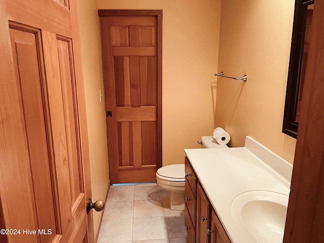 bathroom with tile patterned flooring, vanity, and toilet