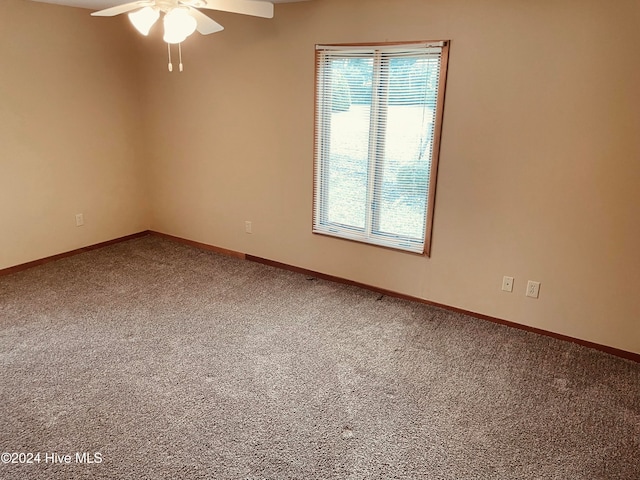 carpeted empty room with a wealth of natural light and ceiling fan