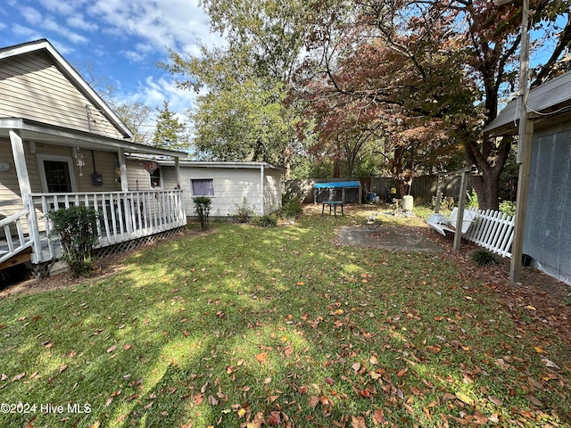 view of yard with a storage unit and a deck