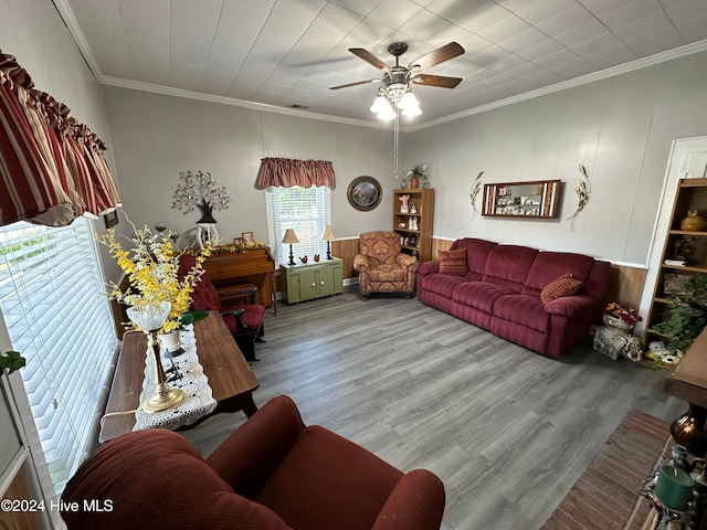 living room featuring ornamental molding, wood-type flooring, and ceiling fan