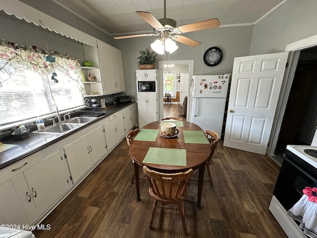 kitchen featuring white appliances, a healthy amount of sunlight, white cabinetry, and sink