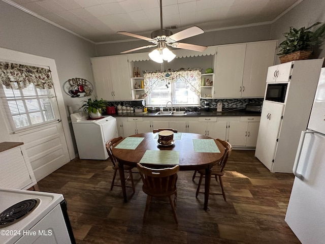 kitchen with white appliances, washer / clothes dryer, dark hardwood / wood-style flooring, and decorative backsplash