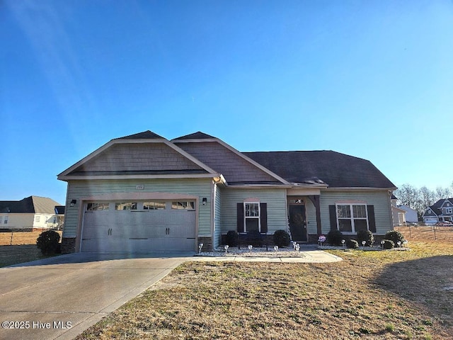 view of front of property with a front yard and a garage