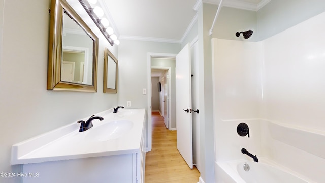 bathroom featuring vanity, shower / bathtub combination, wood-type flooring, and crown molding