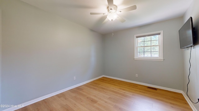 empty room with ceiling fan and light hardwood / wood-style floors