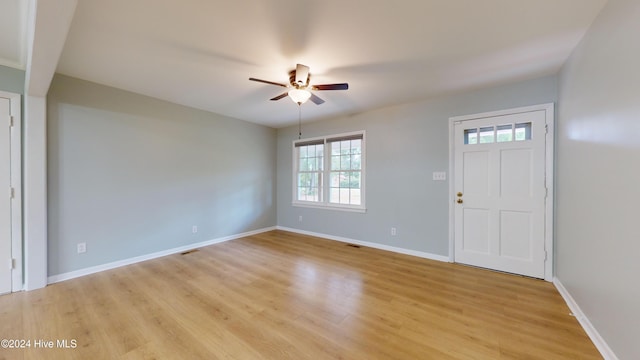 foyer entrance with ceiling fan and light wood-type flooring