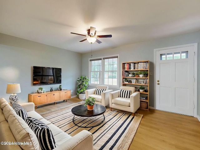 living room featuring light hardwood / wood-style flooring and ceiling fan