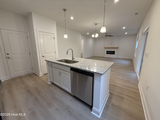 kitchen featuring white cabinetry, ceiling fan, decorative light fixtures, stainless steel dishwasher, and sink