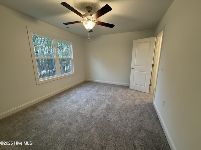 spare room featuring carpet floors and ceiling fan