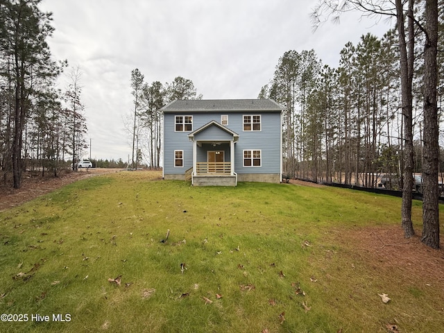 rear view of house with a yard