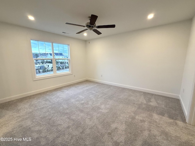 carpeted spare room with ceiling fan