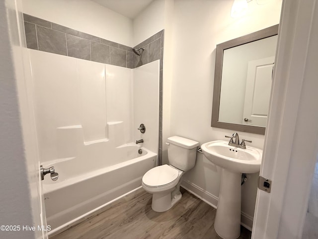 full bathroom featuring hardwood / wood-style floors, shower / bath combination, toilet, and sink