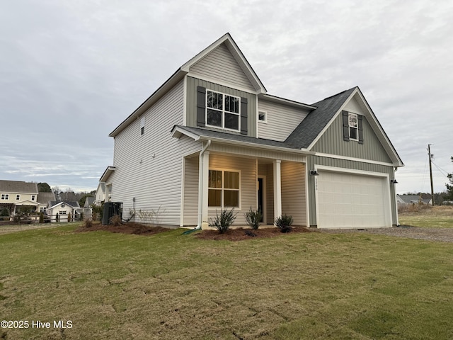 view of front facade with a porch, a front lawn, central AC unit, and a garage