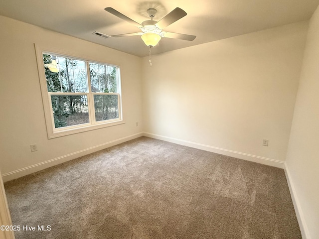 carpeted empty room featuring ceiling fan