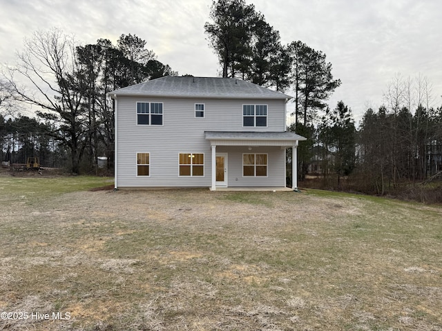 rear view of house with a lawn