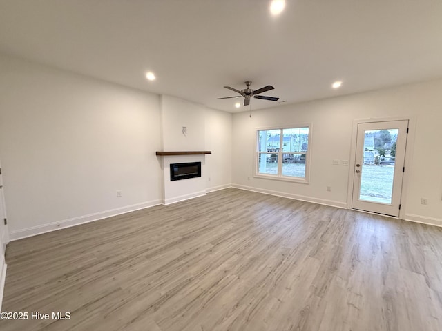 unfurnished living room with light hardwood / wood-style floors and ceiling fan