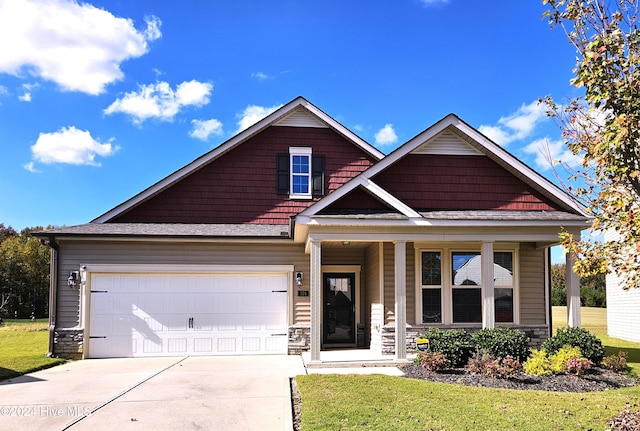 craftsman-style home featuring a front lawn and a garage