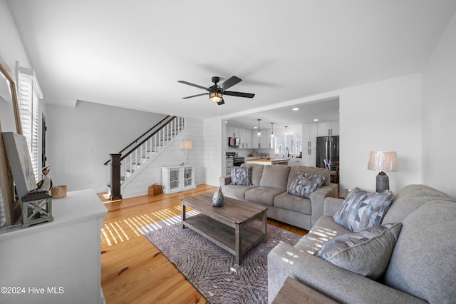 living room with hardwood / wood-style flooring and ceiling fan