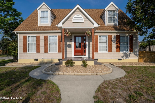 cape cod house with a front yard