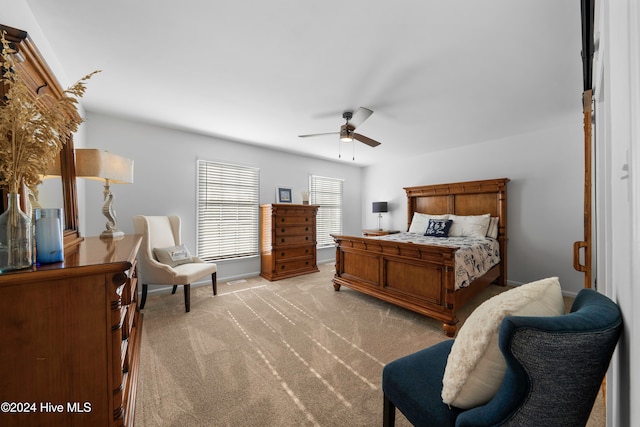 bedroom with ceiling fan and light carpet