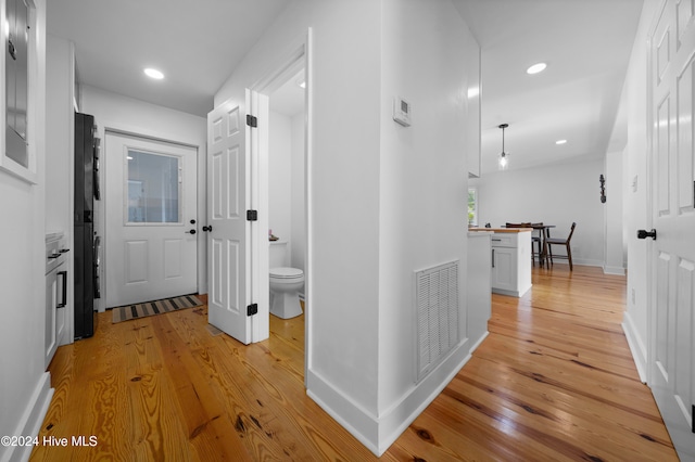 hallway with light hardwood / wood-style flooring