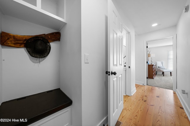 corridor with light hardwood / wood-style floors