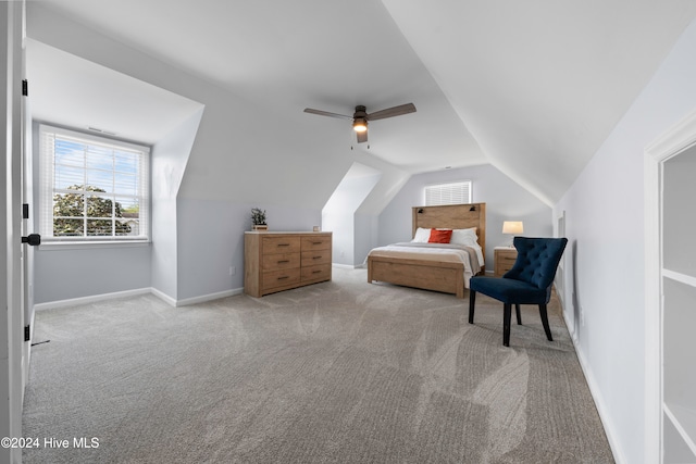 bedroom featuring ceiling fan, light carpet, and lofted ceiling